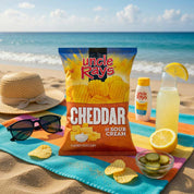 Uncle Ray's Cheddar Sour Cream chips on a beach with sunglasses, hat, and lemonade.
