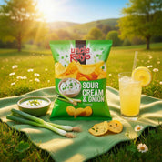 Uncle Ray's Sour Cream & Onion flavored chips on a picnic blanket with a drink and snacks in a scenic outdoor setting.