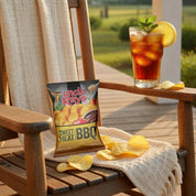 Wooden chair with Uncle Ray's Sweet Heat BBQ chips and a glass of iced tea on a deck.